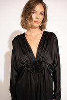 Close up view of model wearing Floral Detail Satin Twill Maxi Dress – Black by Aisl.