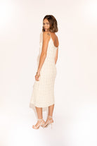 Back view of Hand-Woven Cotton Midi Dress with Floral Detail – Ivory.