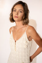 Close-up view of model with Hand-Woven Cotton Midi Dress with Floral Detail – Ivory.