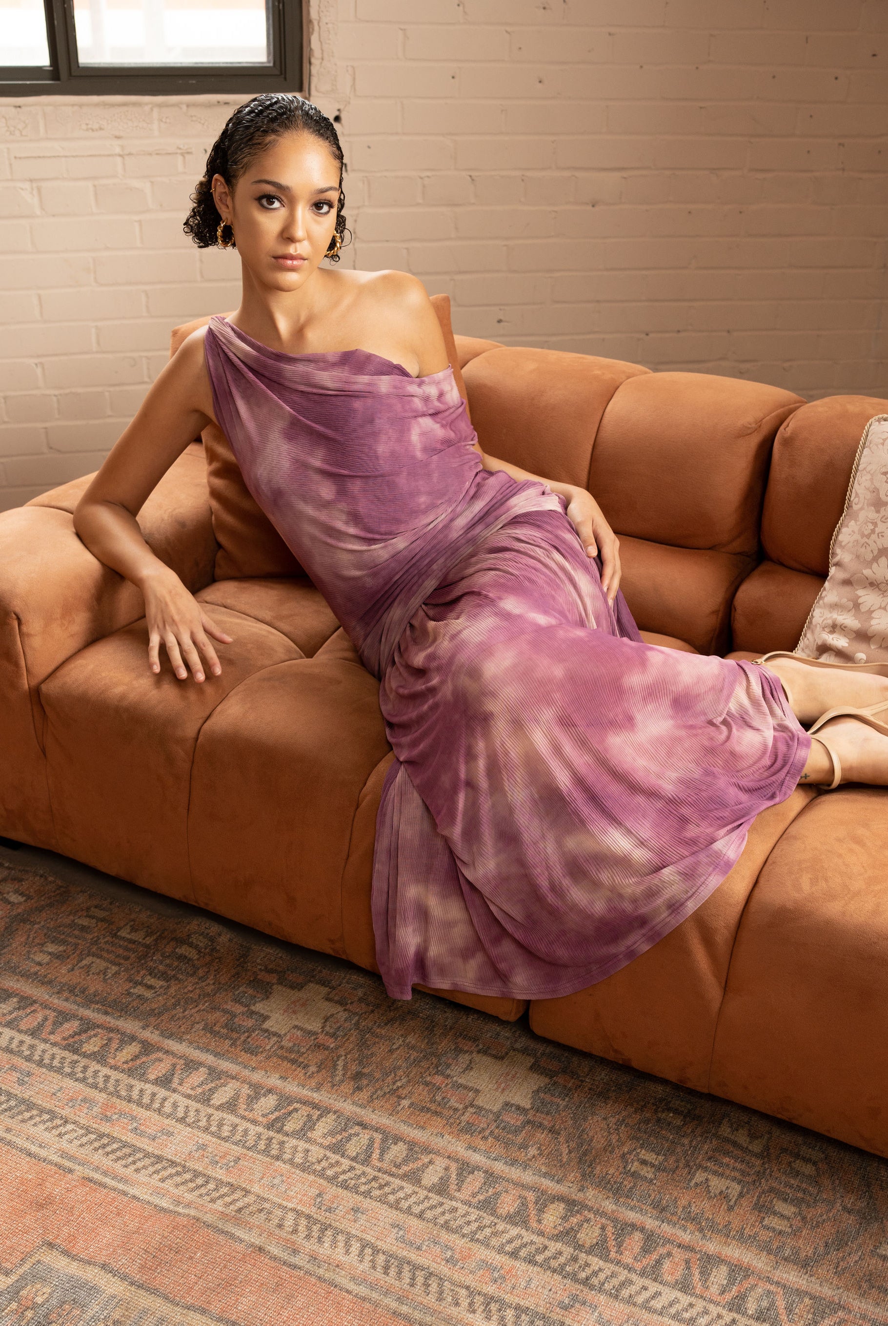 One-Shoulder Tie-Dye Pleated Maxi Dress – Lilac, Model Sitting