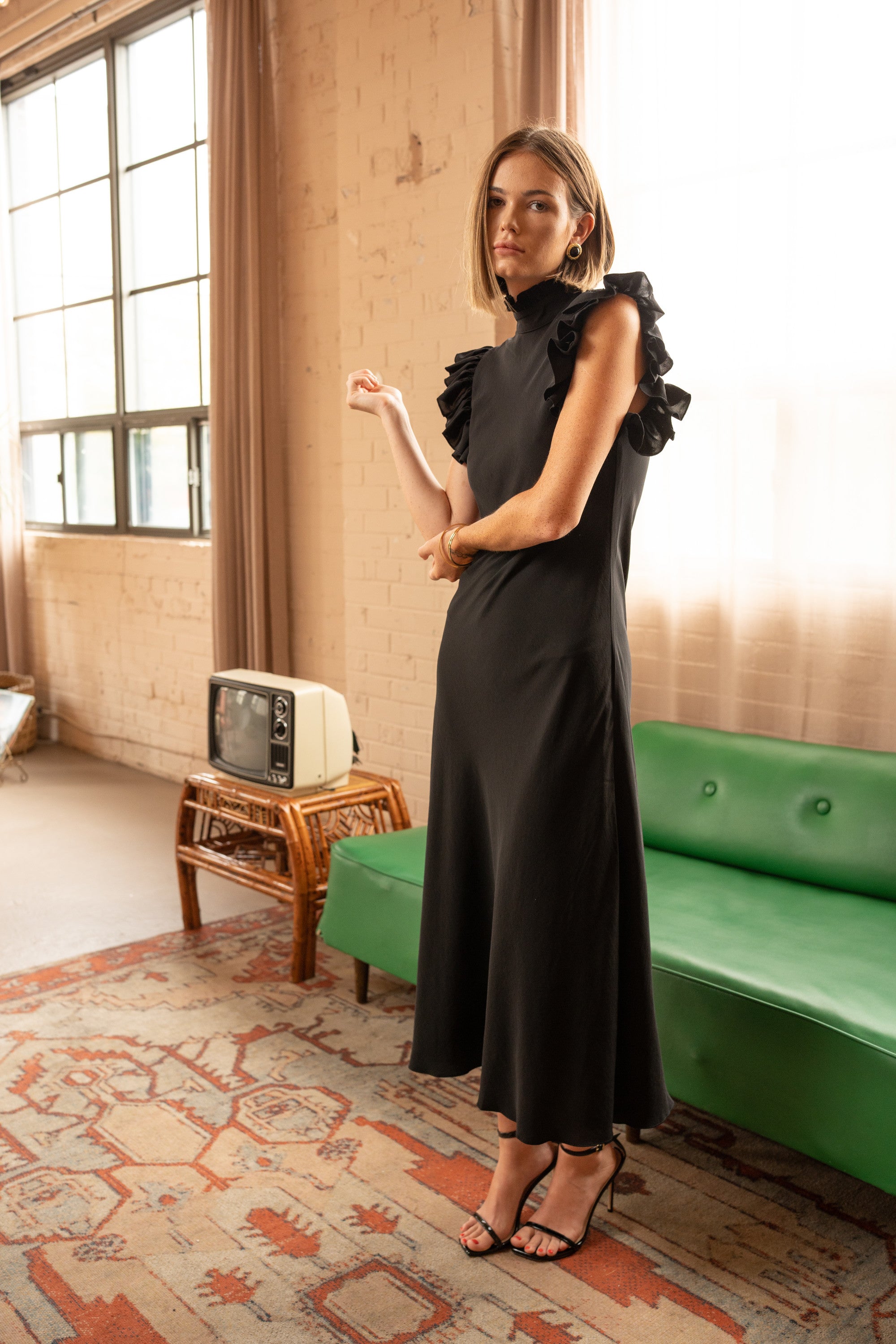 Front view of High-Neck Ruffle Sleeve Maxi Dress – Black by Aisl. 