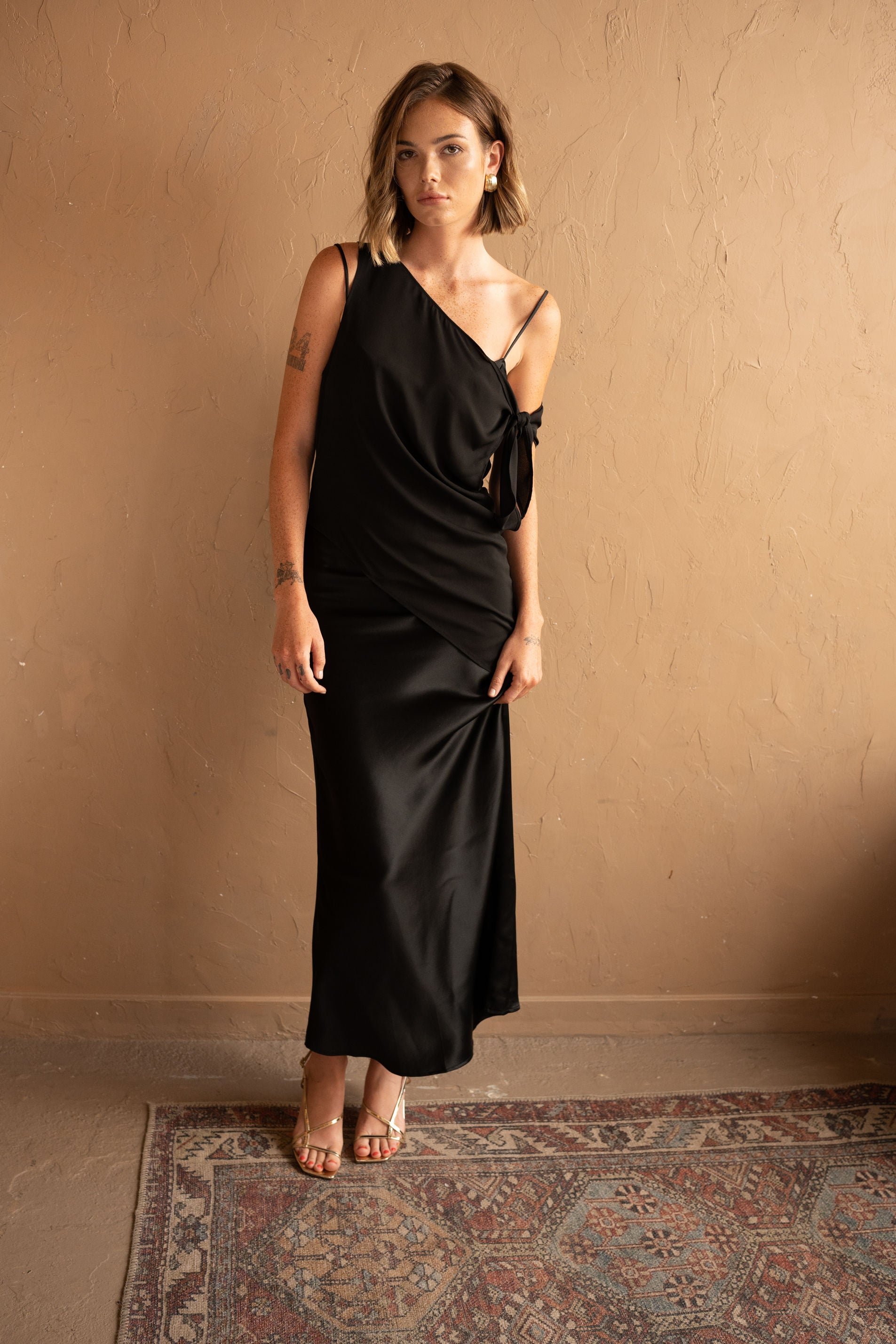 Front view of Asymmetrical Mesh-Spliced Satin Maxi Dress – Black by Aisl. 