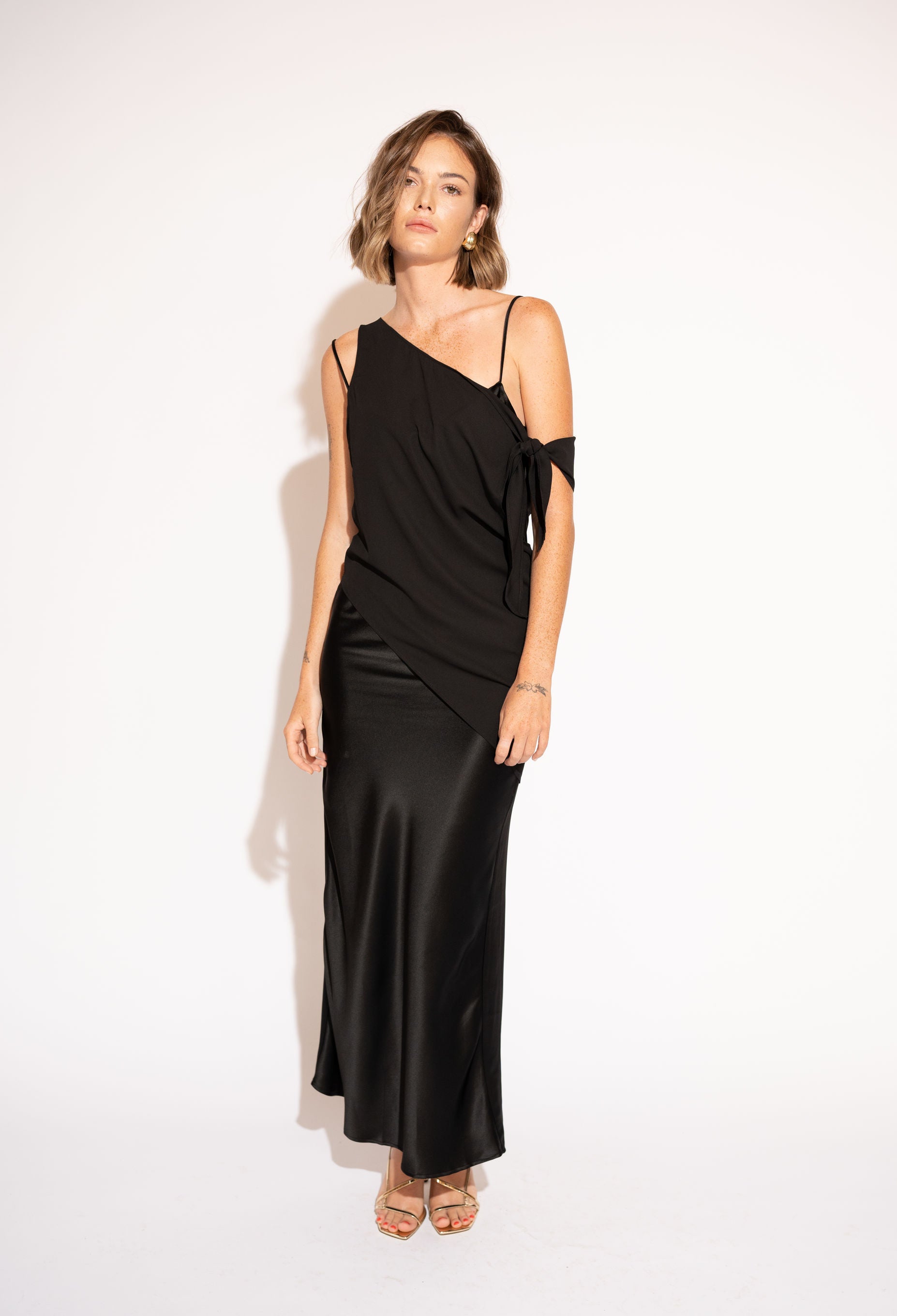 Front view with white background of Asymmetrical Mesh-Spliced Satin Maxi Dress – Black by Aisl. 